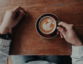 Midsection of coffee cup on table