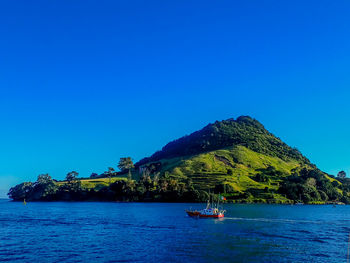 Scenic view of sea against clear blue sky