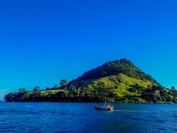 Scenic view of sea against clear blue sky