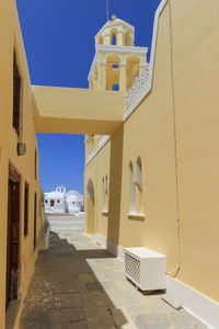 Street and church at oia island by beautiful day, greece