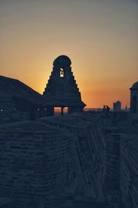 Historic building against sky during sunset