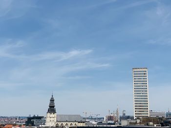 Low angle view of buildings against cloudy sky