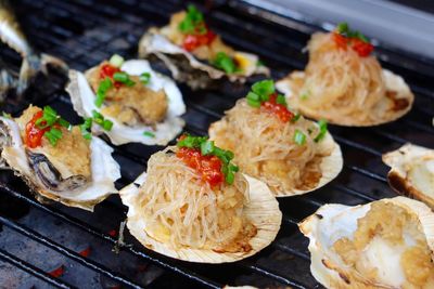 High angle view of oysters cooking on barbecue grill