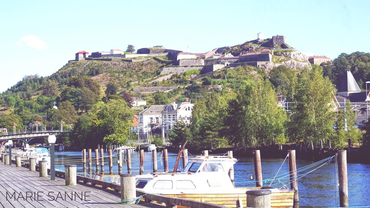 BOATS MOORED AT HARBOR AGAINST SKY