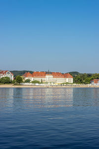 Scenic view of lake against buildings