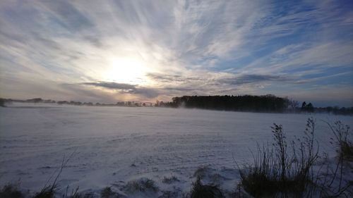 Scenic view of frozen lake against sky during winter