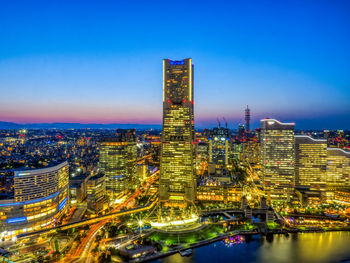 High angle view of illuminated cityscape against sky at night