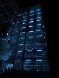 Low angle view of illuminated building against sky at night