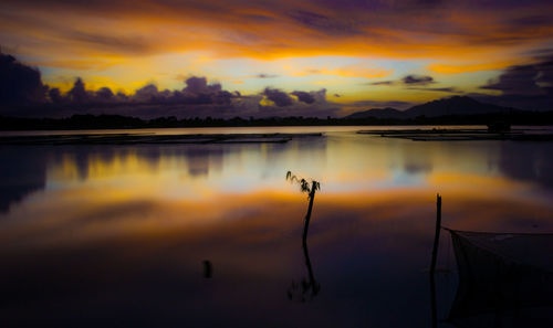 Scenic view of lake against orange sky