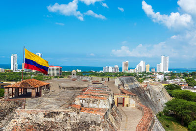 Columbian flag over castillo san felipe de barajas against sky on sunny day