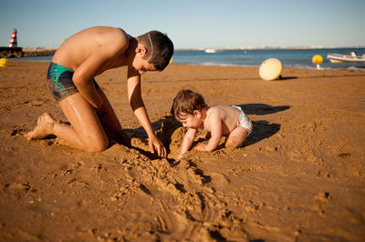 Children playing on sand at beach