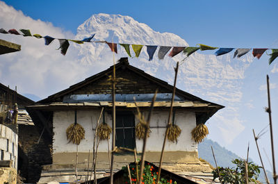 Low angle view of flags hanging against mountain