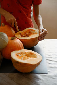 Midsection of man holding pumpkin