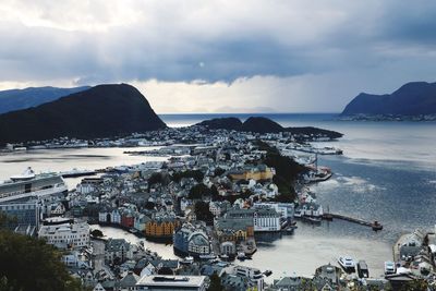 High angle view of bay and buildings against sky