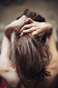 Portrait of woman with hands on hair