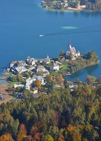 High angle view of townscape by sea against sky