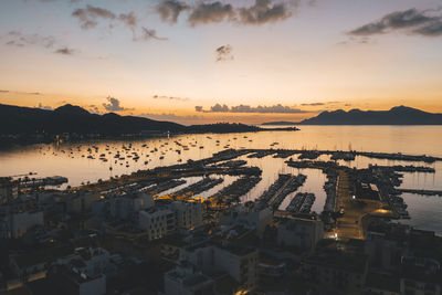 Aerial view over golden sunset in harbor bay with boats in spain