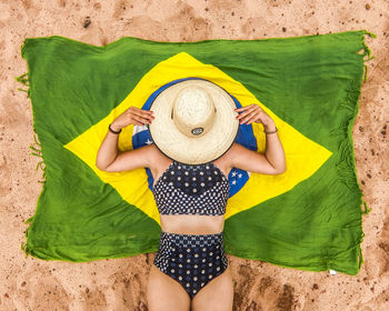 Rear view of woman with arms raised