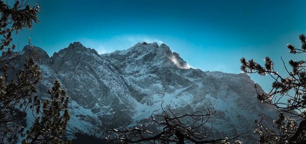 Scenic view of mountains against blue sky