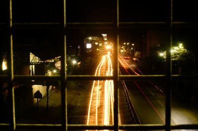 Illuminated light trails on street in city at night