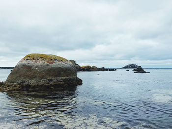 Rocks on shore against sky