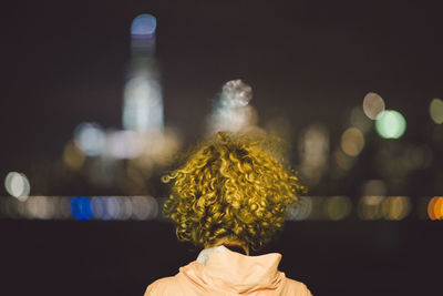 Rear view of woman at night