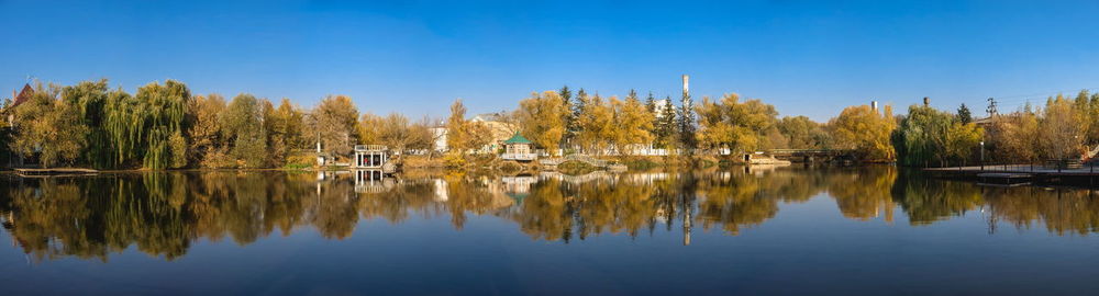 Autumn landscape with a lake and yellow trees in the village of ivanki, cherkasy region, ukraine