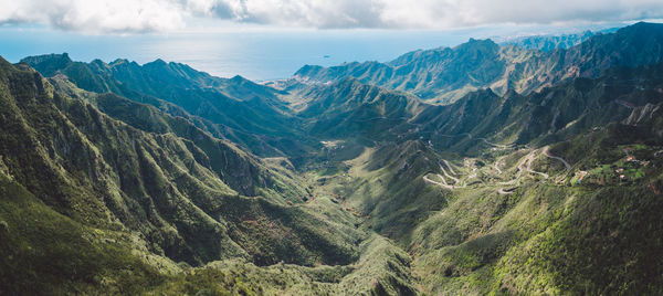 Scenic view of mountains against cloudy sky