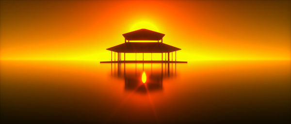 Gazebo in sea against sky during sunset