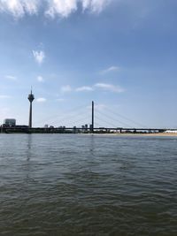 View of bridge over river against cloudy sky