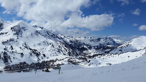 Scenic view of snow covered mountains against sky