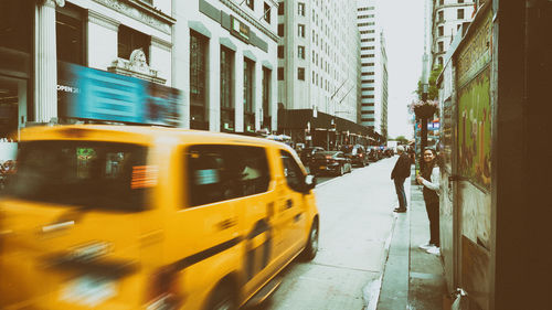 Blurred motion of man walking on street in city