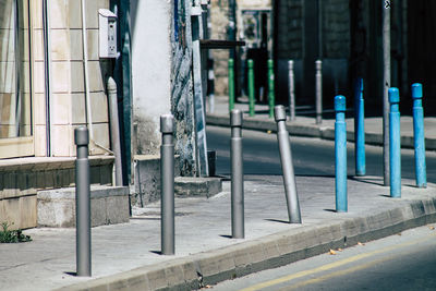 Metallic structure on footpath by building