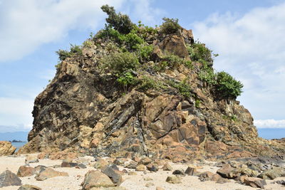 Low angle view of rock formation against sky