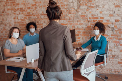 People discussing business activity in office