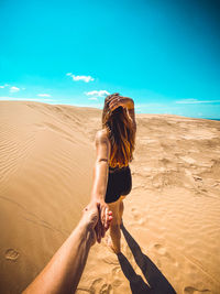 Full length of woman walking on sand at beach