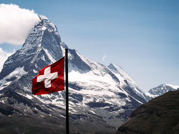 Matterhorn mountain with swiss flag scenery and clear sky background