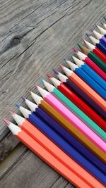 High angle view of colored pencils on wooden table
