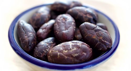High angle view of roasted coffee beans in bowl