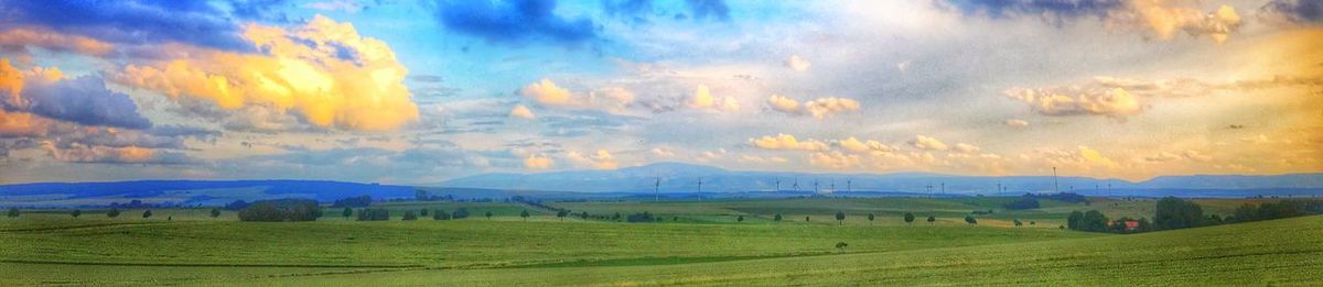 Scenic view of landscape against cloudy sky