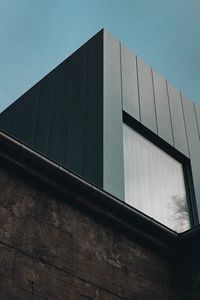 Low angle view of modern building against clear blue sky