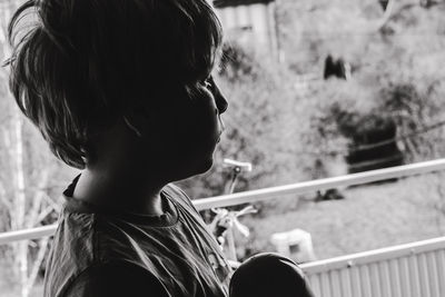 Close-up of boy looking away in balcony