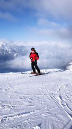 Full length of man on snow covered mountain against sky