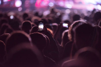 People photographing at music concert