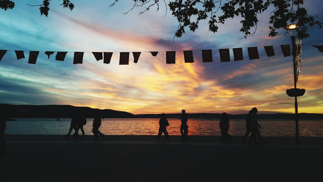 SILHOUETTE PEOPLE AT BEACH DURING SUNSET