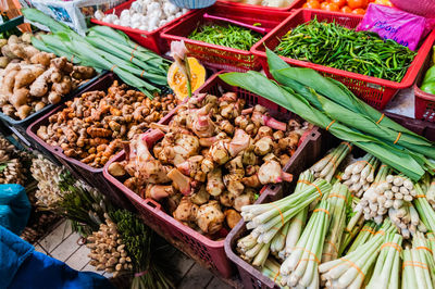 High angle view of various vegetables in crates for sale at market