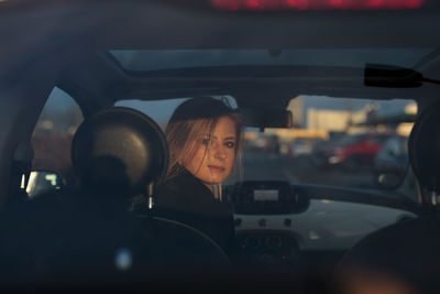 Reflection of woman in car