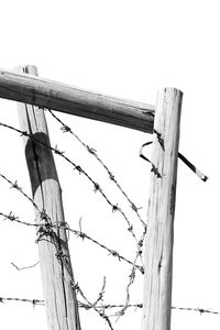 Low angle view of barbed wire against clear sky