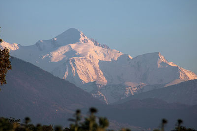 Aerial view of snowcapped mountains against sky