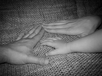 Cropped image of family hands on textile